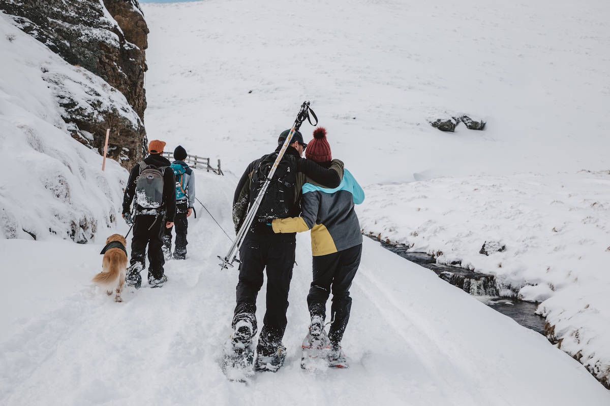 Snow Farm couple hugging walking