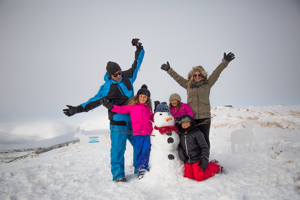 Snow Farm family building snowman